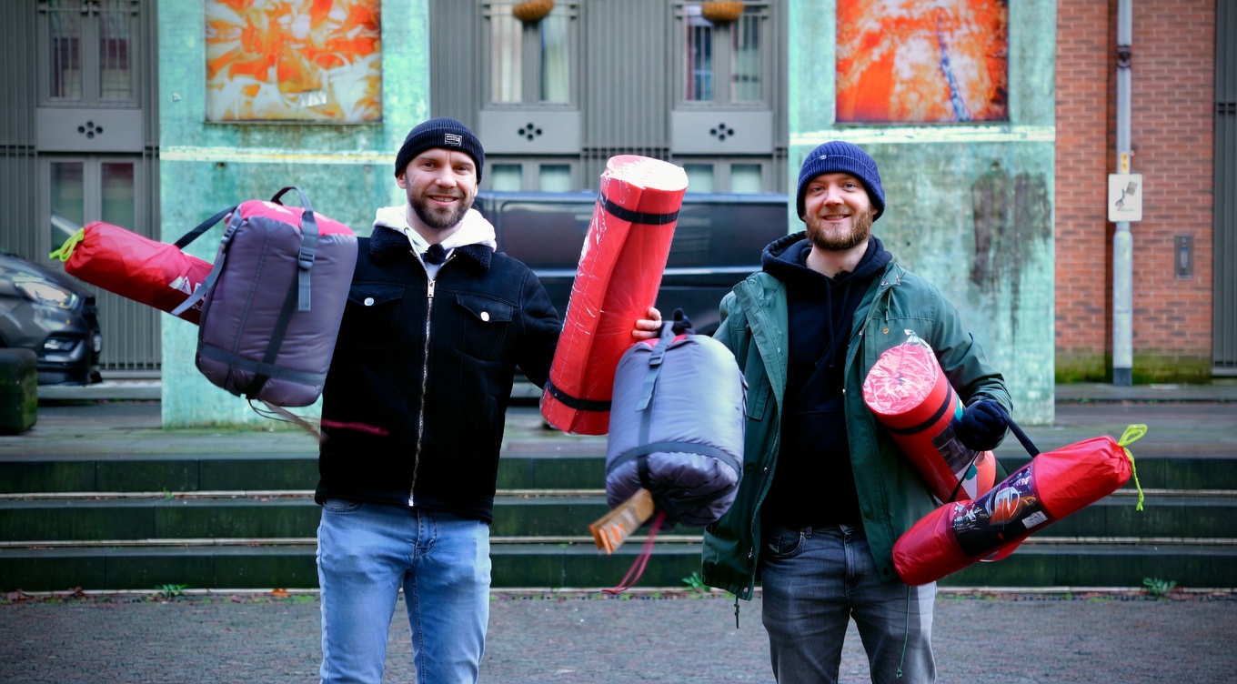 Anthony Hautin and Anton Hilton carrying sleeping bags and mats for a Raffle Aid outreach